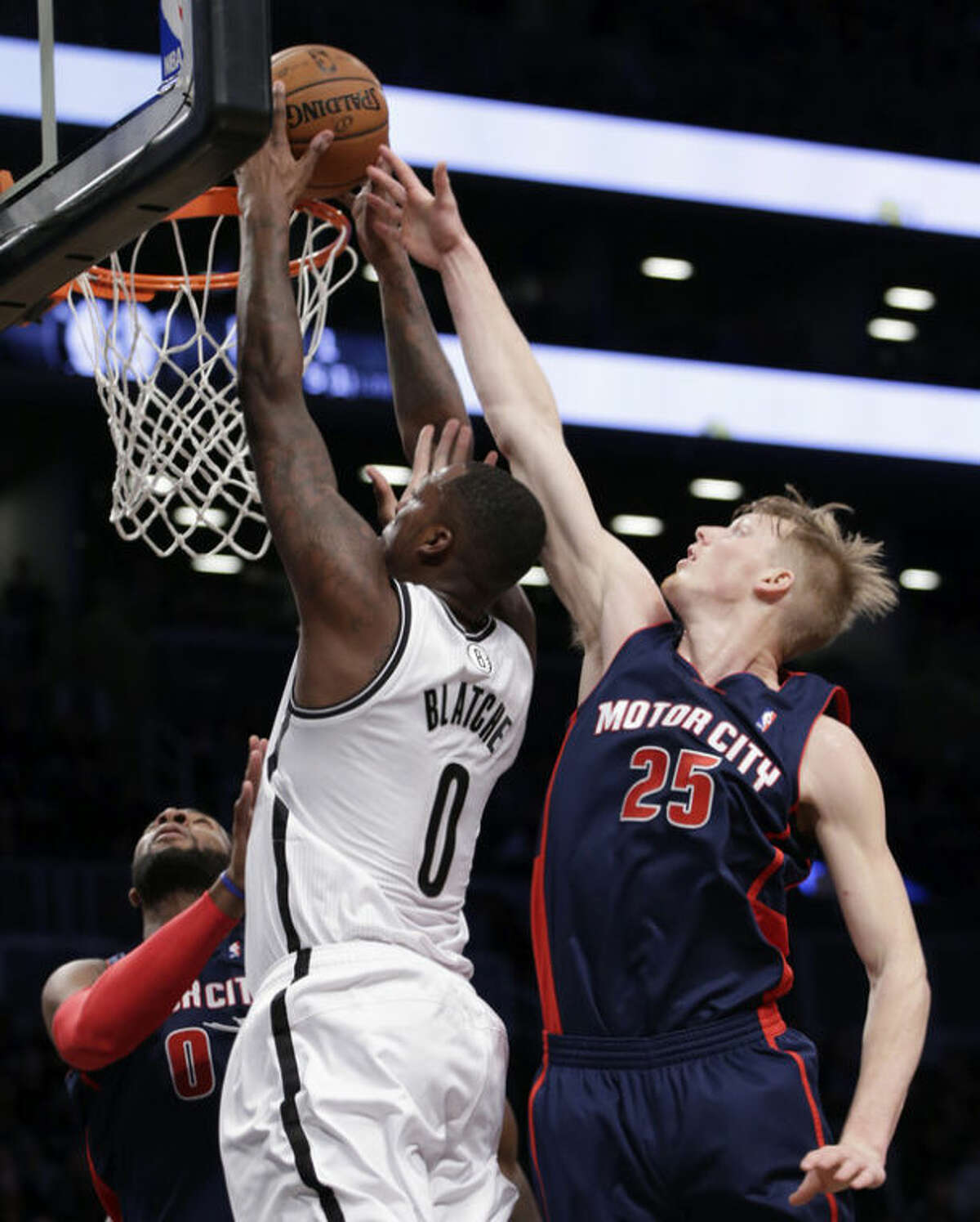 Detroit Pistons forward Kyle Singler (25) tries to block a shot by Brooklyn Nets center Andray Blatche (0) in the first half of an NBA basketball game, Sunday, Nov. 24, 2013, in New York. (AP Photo/Kathy Willens)