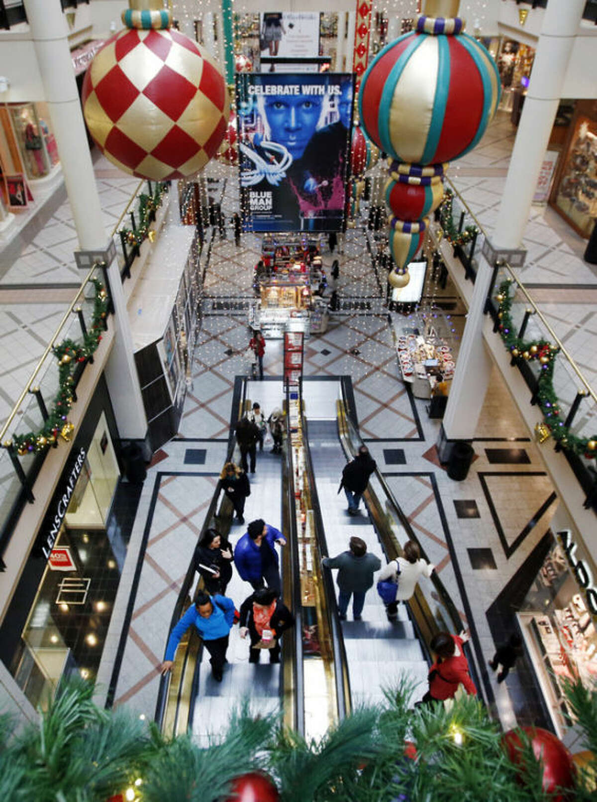 Shoppers ride escalators in a mall in Cambridge, Mass., Tuesday, Nov. 26, 2013. Shoppers in many states will line up for deals hours after their Thanksgiving dinners, but stores in a handful of states are barred by law from opening on the holiday. Rhode Island, Massachusetts and Maine have so-called ?“blue laws?” that bar many big stores from opening Thursday. (AP Photo/Elise Amendola)