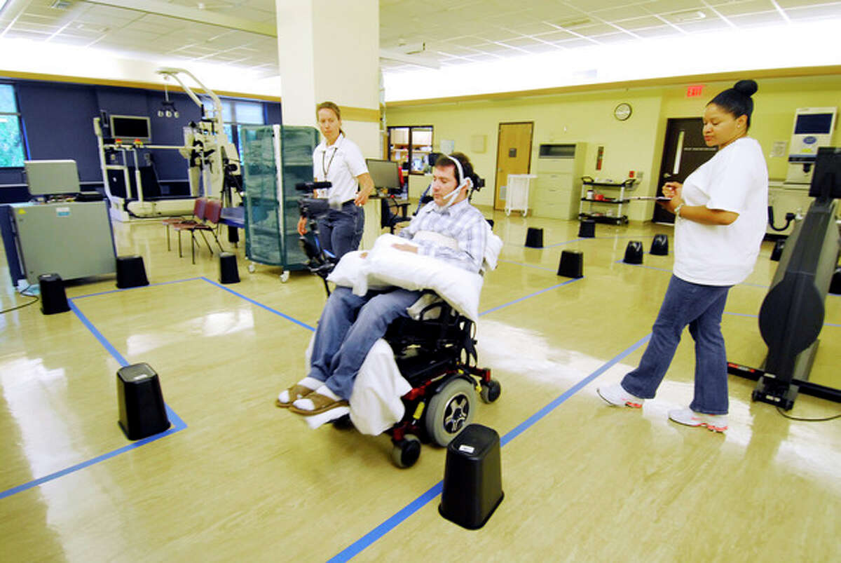 This undated handout photo provided by the Shepherd Center shows Jason DiSanto navigating an obstacle course in an electric-powered wheelchair by issuing commands with a magnetic tongue piercing. The 50-meter-long course, at the Shepherd Center in Atlanta, Ga., included 13 turns and 24 obstacles, requiring tongue drive users to make U-turns, move in reverse and negotiate a loop. (AP Photo/Georgia Tech, Gary Meek)