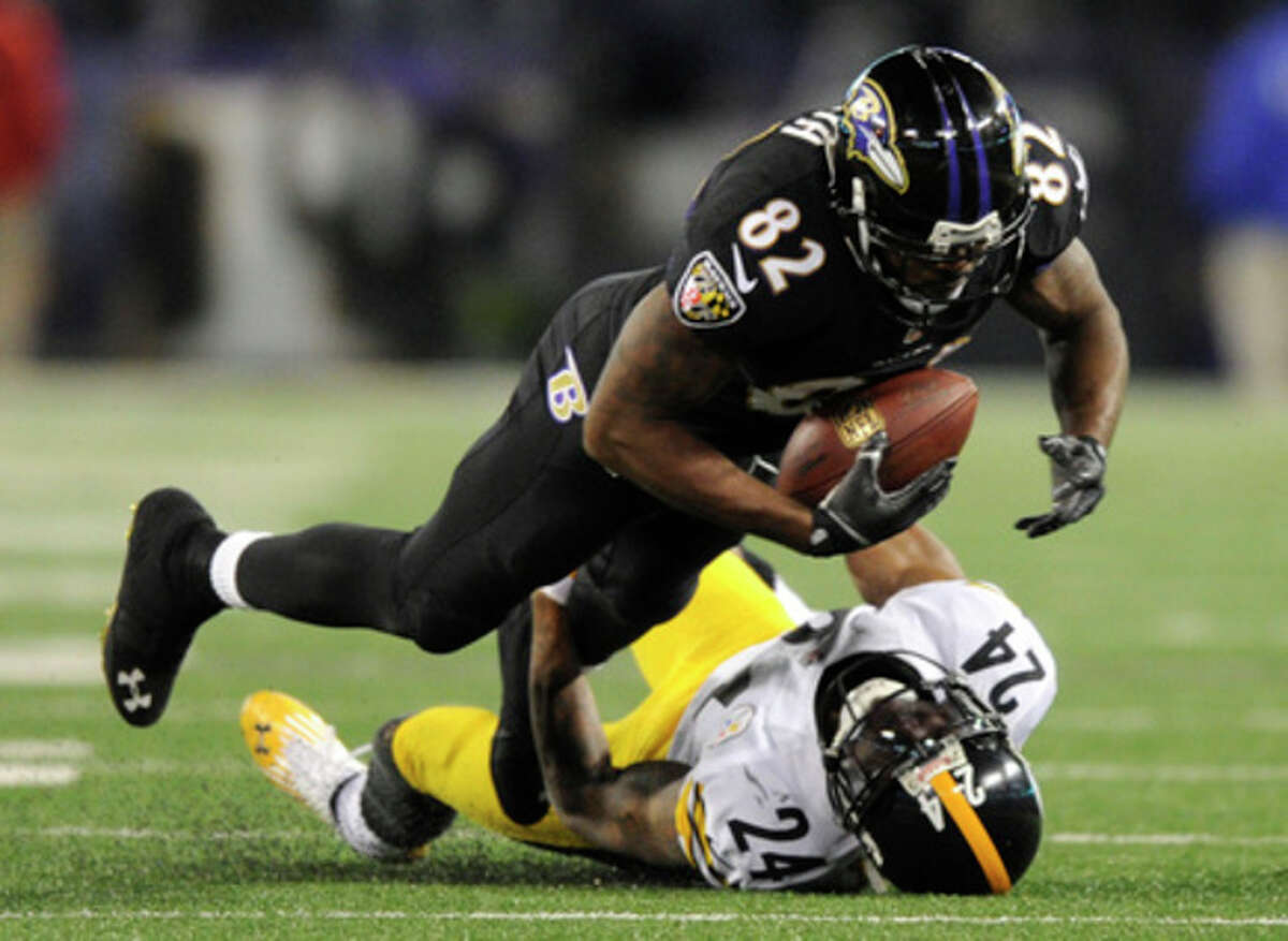 Baltimore Ravens wide receiver Torrey Smith (82) is tackled by Pittsburgh Steelers cornerback Ike Taylor in the second half of an NFL football game, Thursday, Nov. 28, 2013, in Baltimore. Baltimore won 22-20. (AP Photo/Nick Wass)