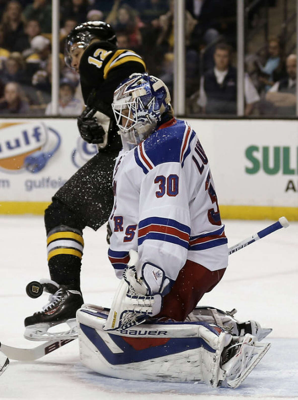 New York Rangers goalie Henrik Lundqvist (30) makes a save as Boston Bruins' Jarome Iginla looks for the rebound during the second period of an NHL hockey game in Boston, Friday, Nov. 29, 2013. (AP Photo/Winslow Townson)