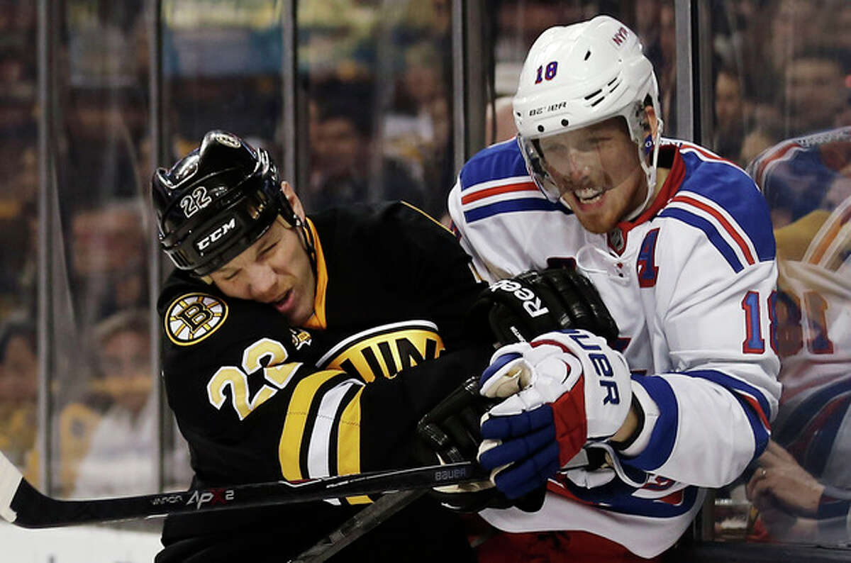 Boston Bruins' Shawn Thornton, left, checks New York Rangers' Marc Staal during the second period of an NHL hockey game in Boston, Friday, Nov. 29, 2013. (AP Photo/Winslow Townson)