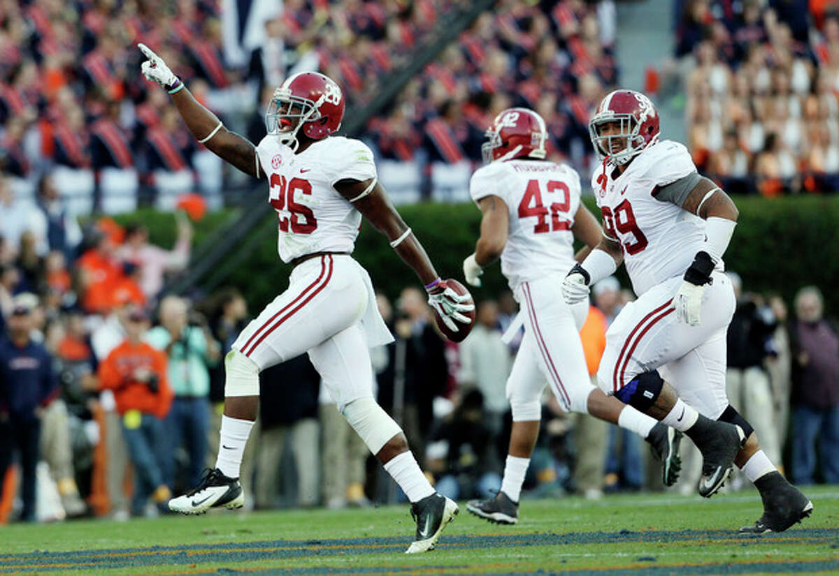 Alabama defensive back Landon Collins (26) reacts after recovering an Auburn fumble during the first half of an NCAA college football game in Auburn, Ala., Saturday, Nov. 30, 2013. (AP Photo/Skip Martin)