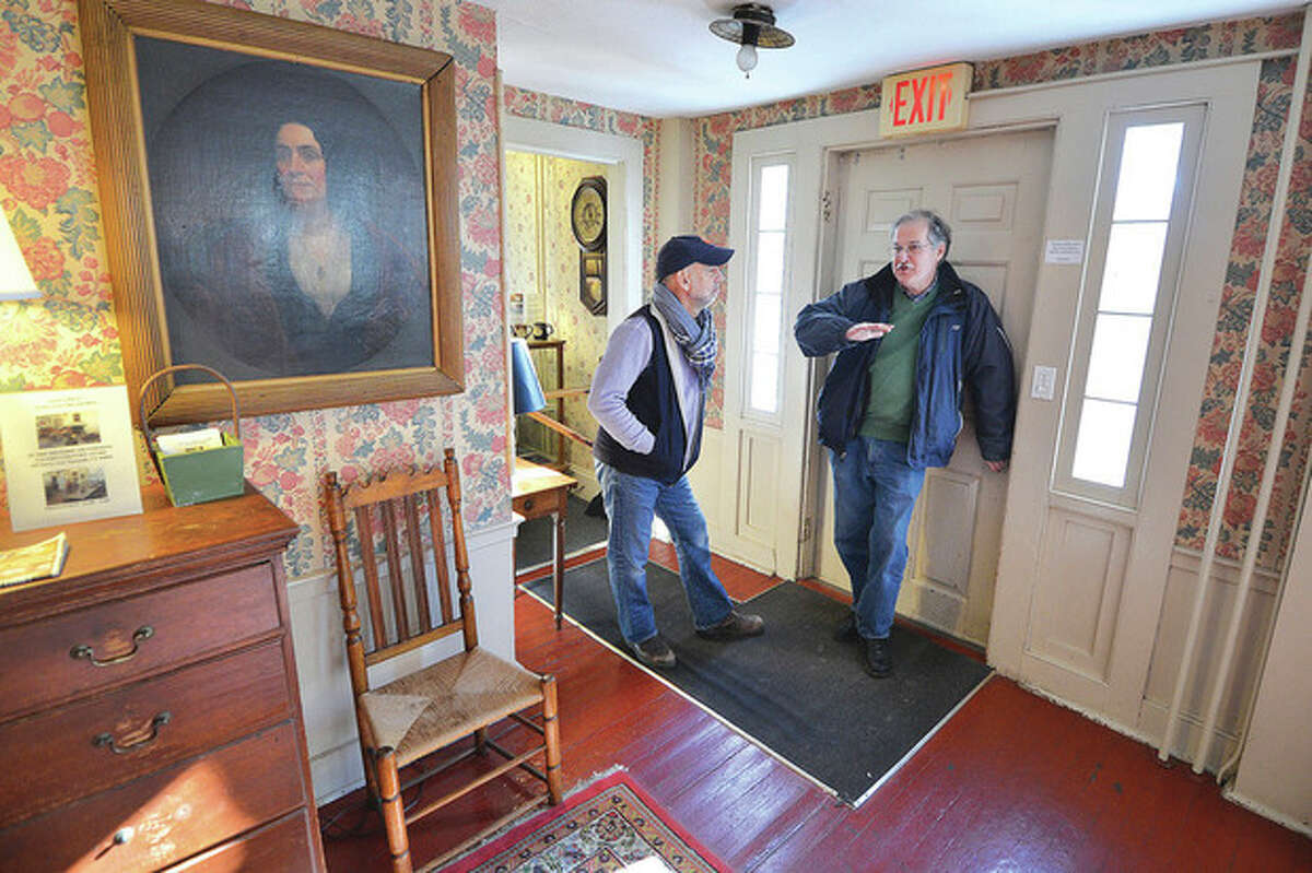 Hour Photo / Alex von Kleydorff . An oil portrait of a woman looks over the main room at The Silvermine Tavern as Owner Frank Whitman and Builder Developer Andrew Glazer talk about whats next for the century old property