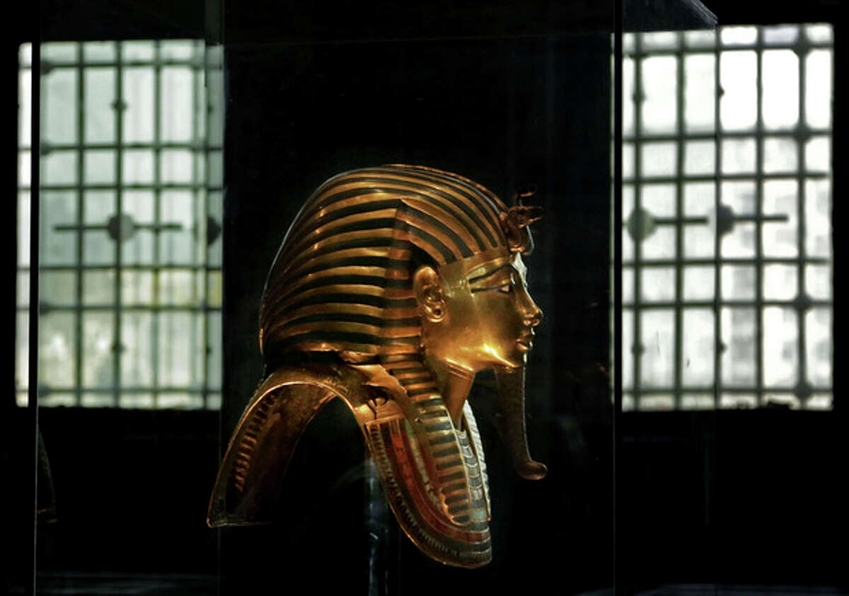 In this Wednesday, Oct. 30, 2013 photo, the solid gold mask of King Tutankhamun is seen in its glass case, in the Egyptian Museum near Tahrir Square in Cairo, Egypt. The 111-year-old museum, a treasure trove of pharaonic antiquities, has long been one of the centerpieces of tourism to Egypt. But the constant instability since the 2011 uprising that toppled autocrat Hosni Mubarak has dried up tourism to the country, slashing a key source of revenue. Moreover, political backbiting and attempts to stop corruption have had a knock-on effect of bringing a de facto ban on sending antiquities on tours to museums abroad, cutting off what was once a major source of funding for the museum. (AP Photo/Nariman El-Mofty)