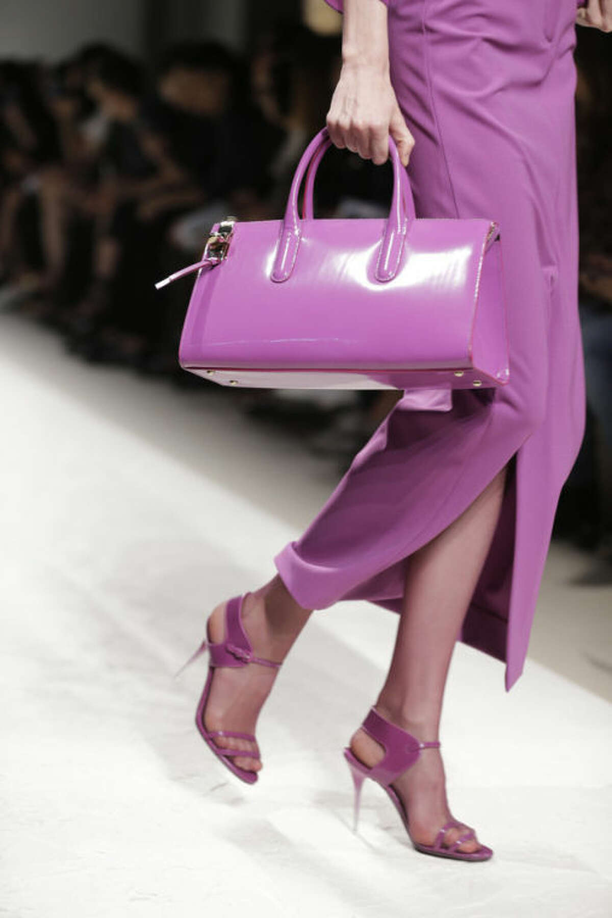 FILE - In this Sept. 19, 2013 file photo, a model wears a creation for Max Mara women's Spring-Summer 2014 collection, part of the Milan Fashion Week, unveiled in Milan, Italy. Orchid is growing on us: A version of the purple hue is Pantone Inc.?’s color of the year for 2014. AP Photo/Luca Bruno)