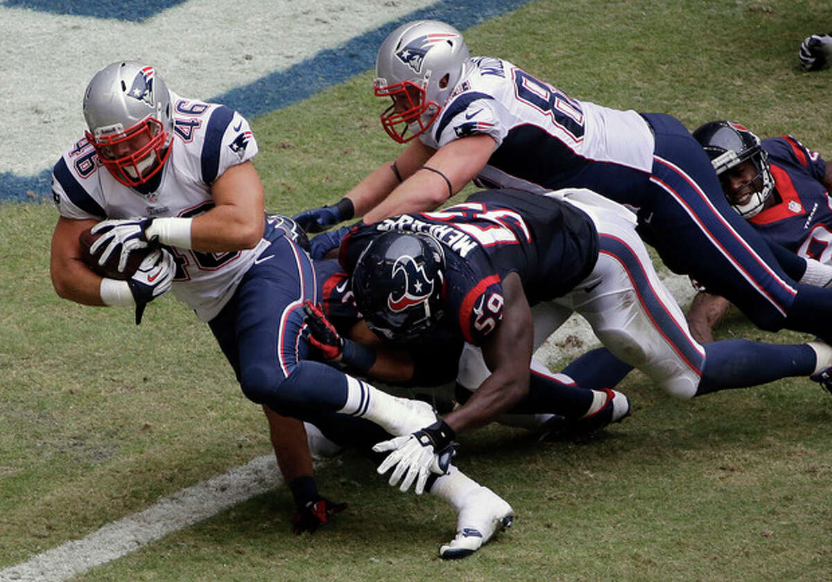 New England Patriots' James Develin (46) scores a touchdown against the Houston Texans during the third quarter of an NFL football game on Sunday, Dec. 1, 2013, in Houston. (AP Photo/David J. Phillip)