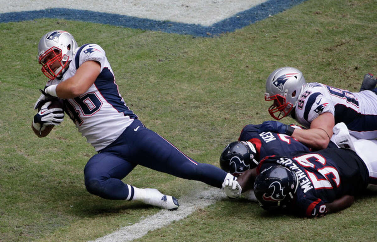New England Patriots' James Develin (46) scores a touchdown against the Houston Texans during the third quarter of an NFL football game on Sunday, Dec. 1, 2013, in Houston. (AP Photo/David J. Phillip)