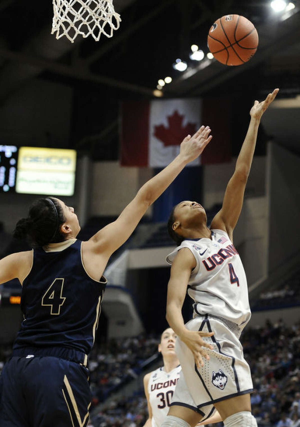 Connecticut's Moriah Jefferson, right, shoots over UC Davis' Idit Oryon, left, during the first half of an NCAA college basketball game, Thursday, Dec. 5, 2013, in Hartford, Conn. (AP Photo/Jessica Hill)