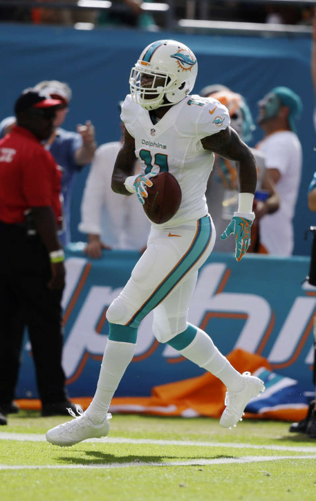 Miami Dolphins wide receiver Mike Wallace (11) scores a touchdown during the first half of an NFL football game against the Carolina Panthers, Sunday, Nov. 24, 2013, in Miami Gardens, Fla. (AP Photo/Lynne Sladky)