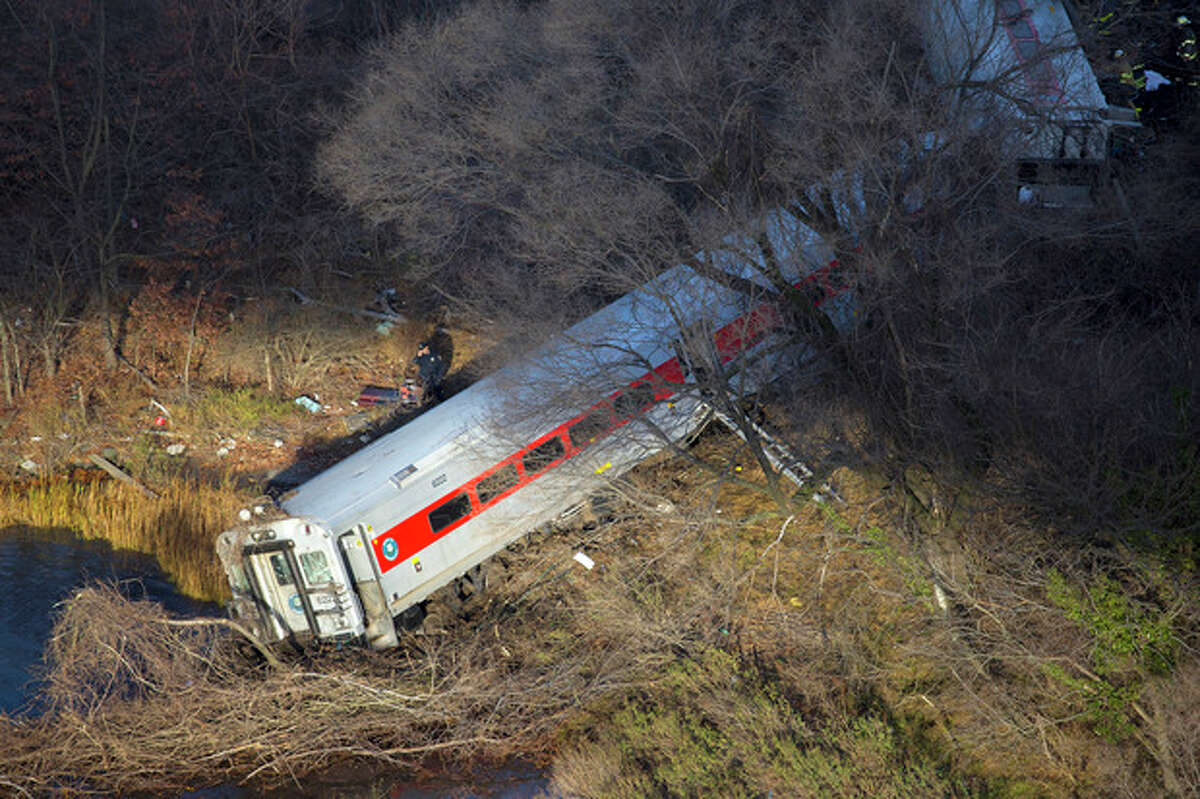 First responders gather around the derailment of a Metro North passenger train in the Bronx borough of New York Dec. 1, 2013 The Fire Department of New York says there are "multiple injuries" in the train derailment, and 130 firefighters are on the scene. Metropolitan Transportation Authority police say the train derailed near the Spuyten Duyvil station. (AP Photo/Craig Ruttle)