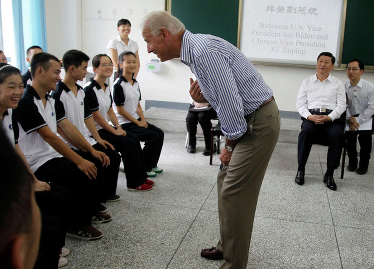 Ap photo In this Aug. 21, 2011, file photo. U.S. Vice President Joe Biden, center, talks to students as Chinese Vice President Xi Jinping, second from right, watches during their visit to the Qingchengshan High School in Dujiangyan in southwestern China's Sichuan province, Sunday, Aug. 21, 2011.