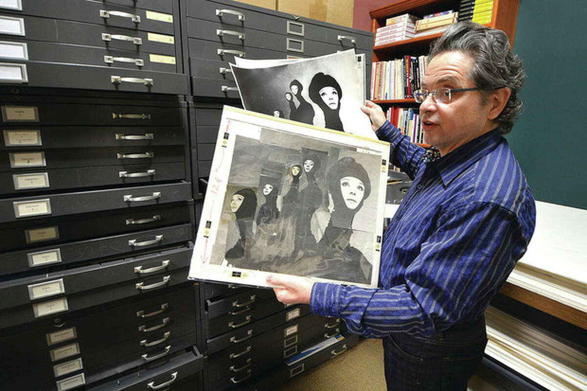 Hour Photo / Alex von Kleydorff Artist's Market owner Jeffrey Price looks over a Richard Avedon photograph of Audrey Hepburn pulled from a file cabinet full of vintage photos from the Archives of the defunct Famous Photographers School in Westport.