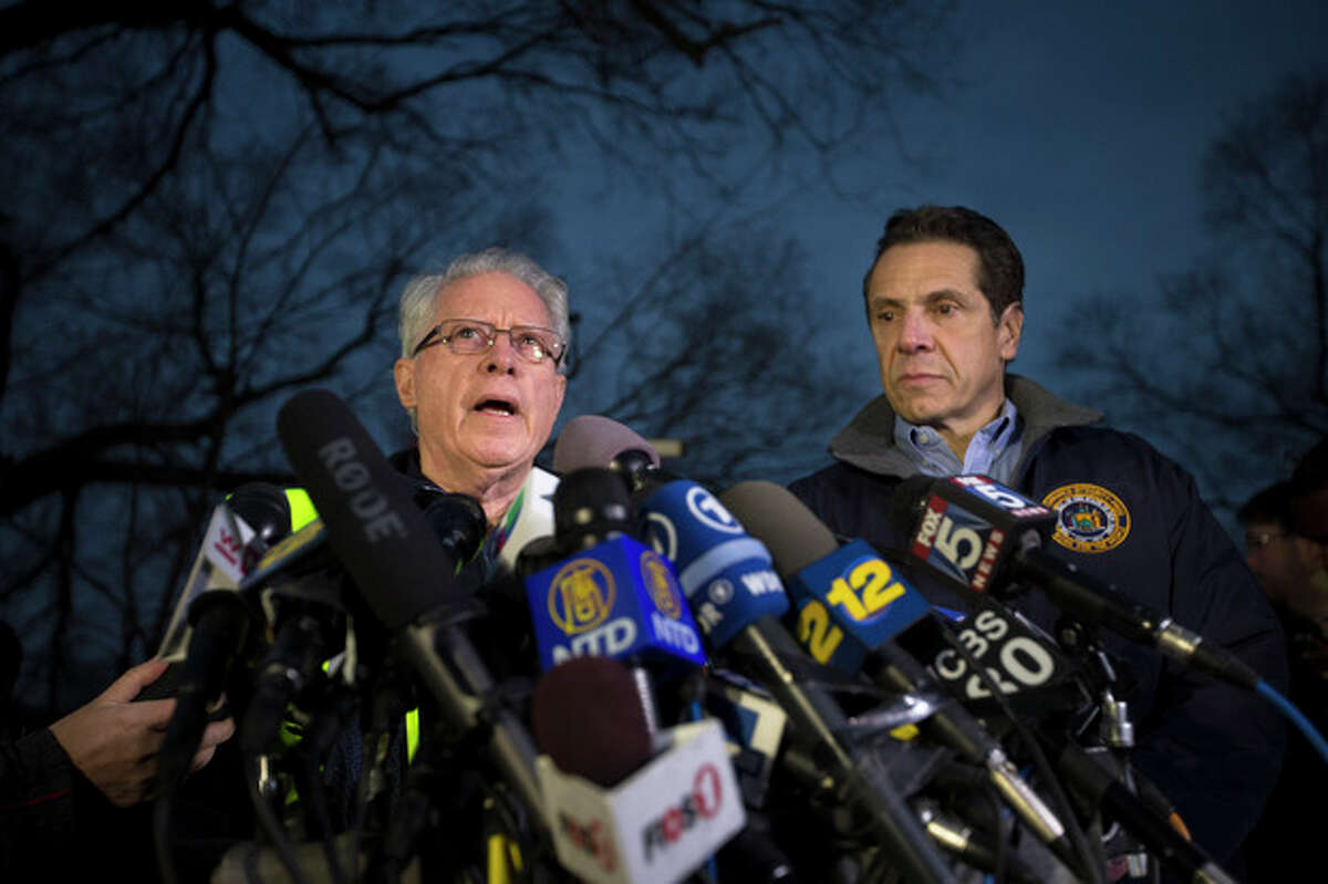 National Transportation Safety Board board member Earl Weener speaks during a news conference alongside New York Governor Andrew Cuomo, right, at the scene of a Metro-North passenger train derailment in the Bronx borough of New York, Sunday, Dec. 1, 2013. The train derailed on a curved section of track in the Bronx on Sunday morning, coming to rest just inches from the water and causing multiple fatalities and dozens of injuries, authorities said. Metropolitan Transportation Authority police say the train derailed near the Spuyten Duyvil station. (AP Photo/John Minchillo)