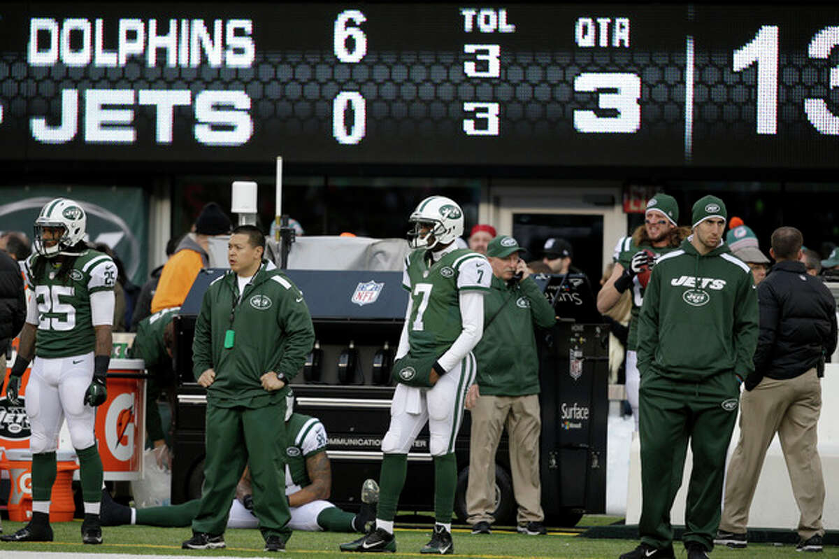 New York Jets quarterback Geno Smith (7) looks on from the sideline after being pulled during the second half of an NFL football game against the Miami Dolphins, Sunday, Dec. 1, 2013, in East Rutherford, N.J. (AP Photo/Seth Wenig)
