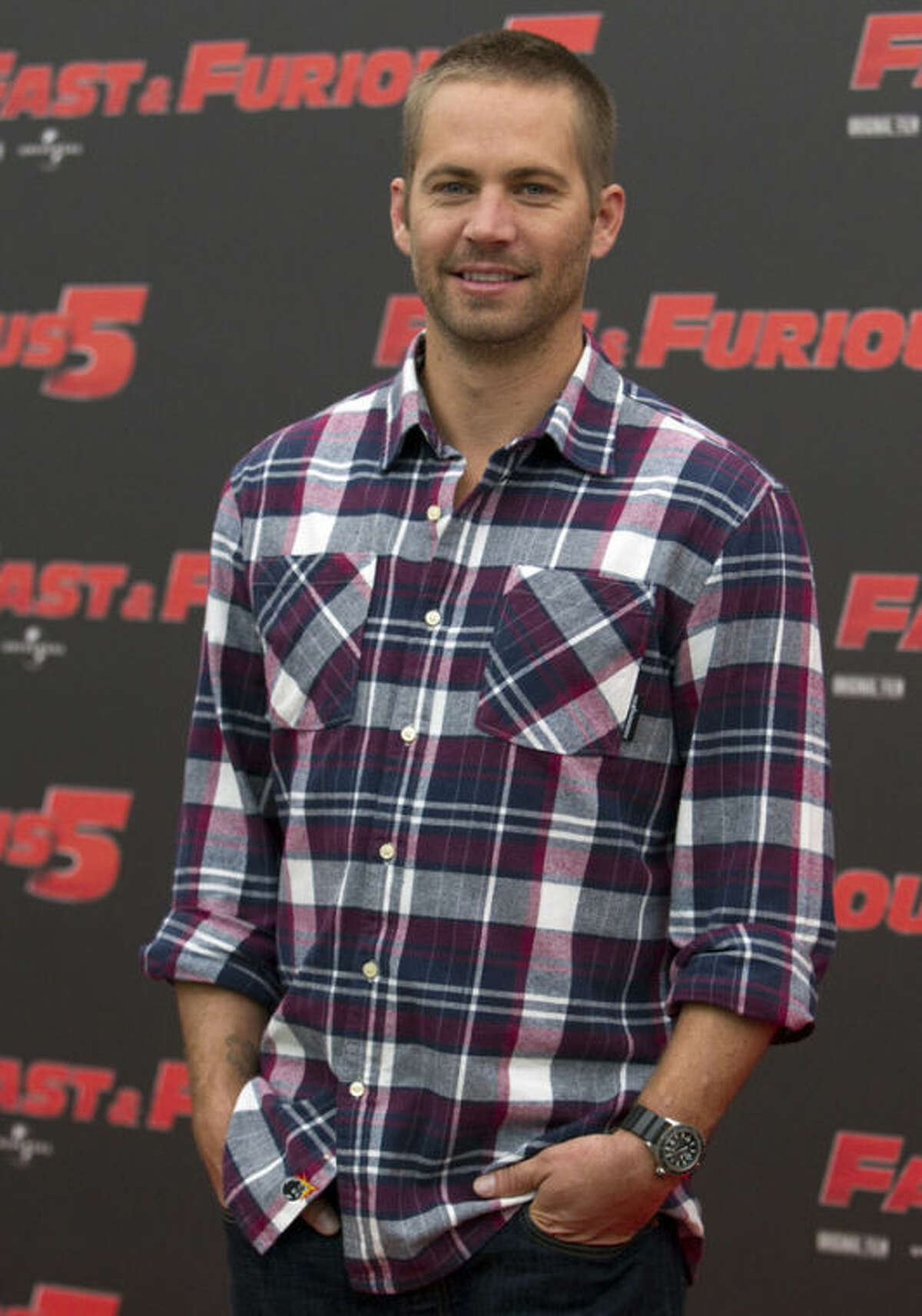 FILE - In this April 29, 2011 file photo, actor Paul Walker poses during the photo call of the movie "Fast and Furious 5," in Rome. The industrial neighborhood where he died in a car crash is known to attract street racers. Walker and his friend and financial adviser Roger Rodas died in the one-car crash Saturday, Nov. 30, 2013, in the Southern California community of Valencia. (AP Photo/Andrew Medichini, File)
