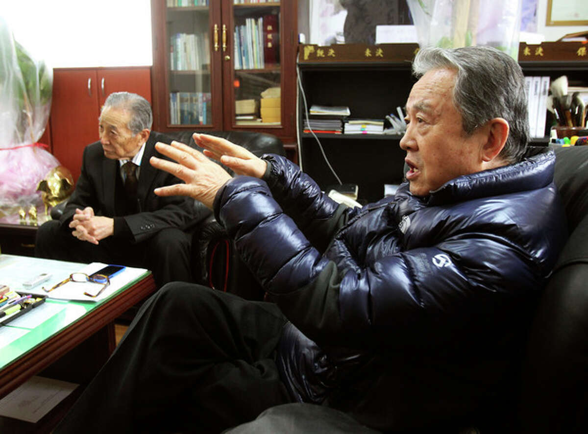 In this Monday, Dec. 2, 2013 photo, Park Young, right, a former member of the Kuwol partisan unit, speaks about Merrill Newman, an elderly American tourist detained in North Korea, during an interview at the Kuwol partisan unit association office in Seoul, South Korea. Six decades before he went to North Korea as a curious tourist, Newman supervised the group of South Korean guerrillas during the Korean War who were perhaps the most hated and feared fighters in the North, former members of the group said. (AP Photo/Ahn Young-joon)