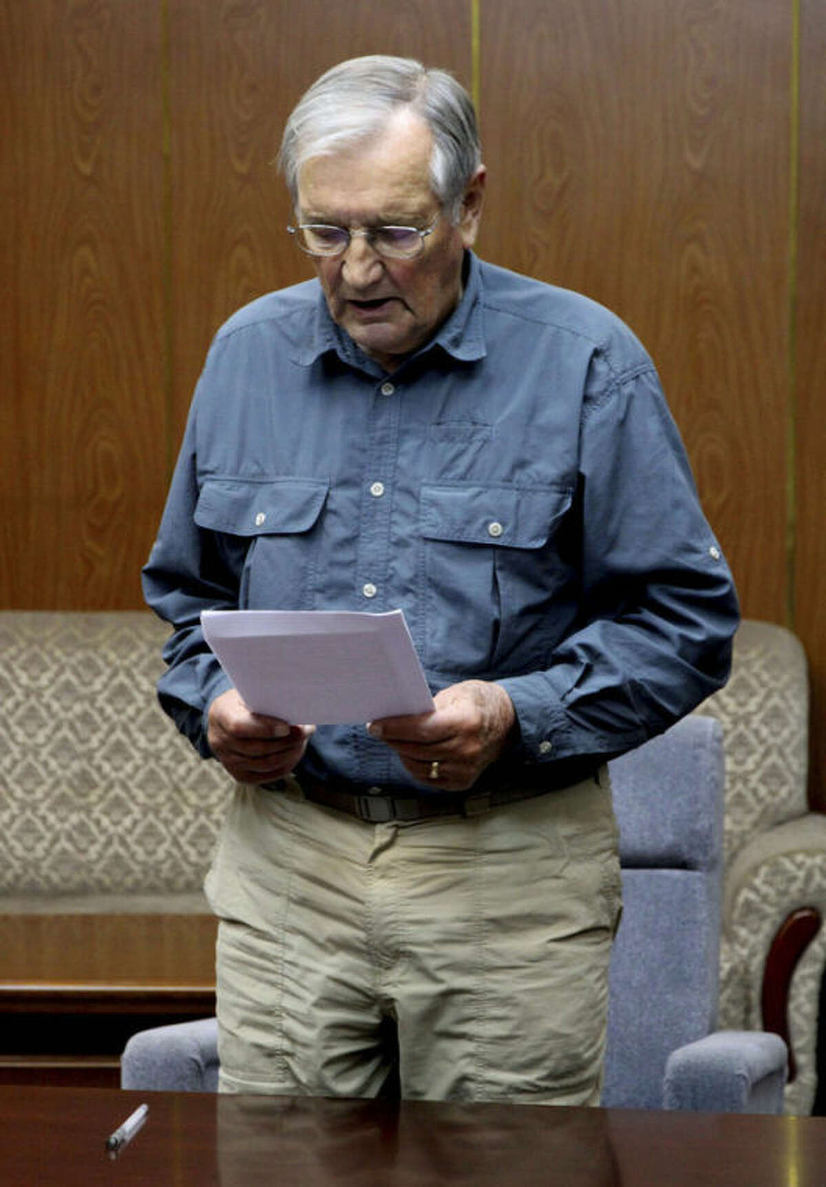 FILE - In this Nov. 9, 2013 file photo released by the Korean Central News Agency (KCNA) and distributed Nov. 30, 2013 by the Korea News Service, U.S. citizen Merrill Newman, 85, reads a document, which North Korean authorities say was an apology that Newman wrote and read in North Korea. Six decades before he went to North Korea as a curious tourist, Newman supervised a group of South Korean guerrillas during the Korean War who were perhaps the most hated and feared fighters in the North, former members of the group say. (AP Photo/KCNA via KNS)