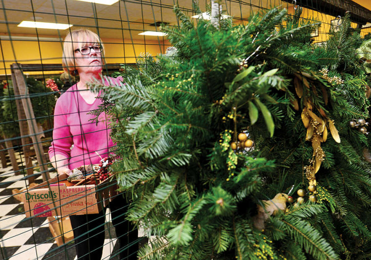Hour photo / Erik Trautmann Rowayton Gardeners Club members including Mary Verel create one-of-a-kind wreaths, boxwoods trees and festive table arrangements for their annual christmas fair this Saturday.