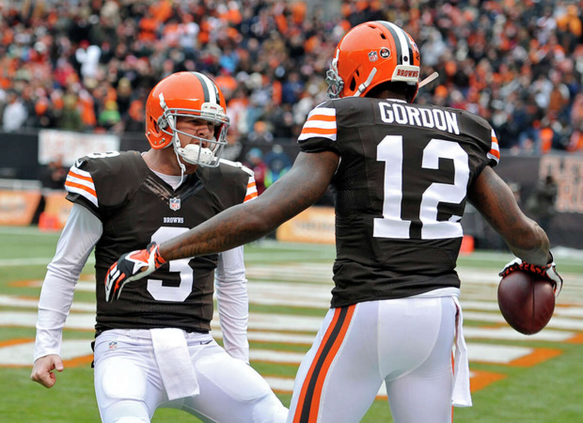 Cleveland Browns quarterback Brandon Weeden (3) celebrates with wide receiver Josh Gordon (12) after they connected on a 21-yard touchdown pass against the Jacksonville Jaguars in the second quarter of an NFL football game on Sunday, Dec. 1, 2013, in Cleveland. (AP Photo/David Richard)
