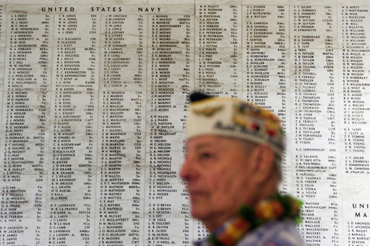 Pearl Harbor survivor Lou Contor stands in the memorial room aboard the USS Arizona Memorial during the ceremony commemorating the 72nd anniversary of the attack on Pearl Harbor, Saturday, Dec. 7, 2013, in Honolulu. (AP Photo/Marco Garcia)