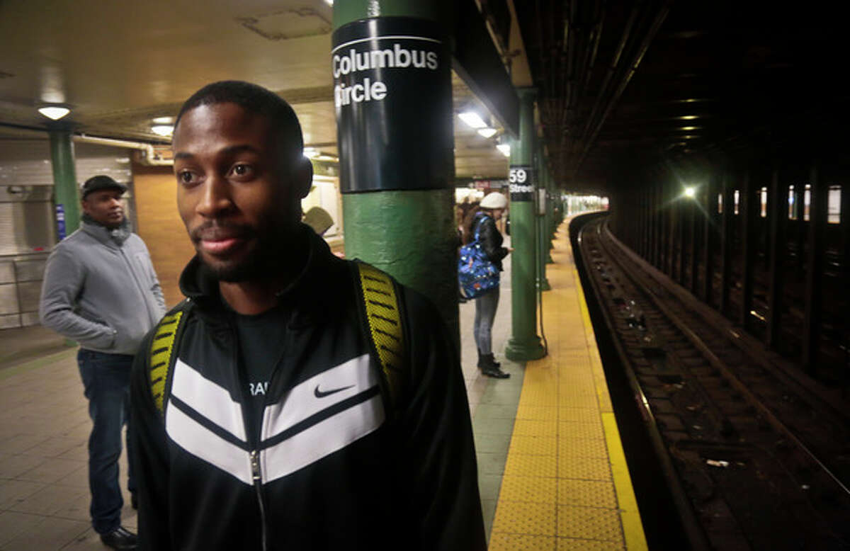 Dennis Codrington, who rescued a man after he onto the subway tracks, stands near the site of the incident on the Columbus Circle subway platform on Thursday, Dec. 5, 2013 in New York. Codrington doesn?’t know what happened to the man he saved, but he hopes he survived and is healthy. (AP Photo/Bebeto Matthews)