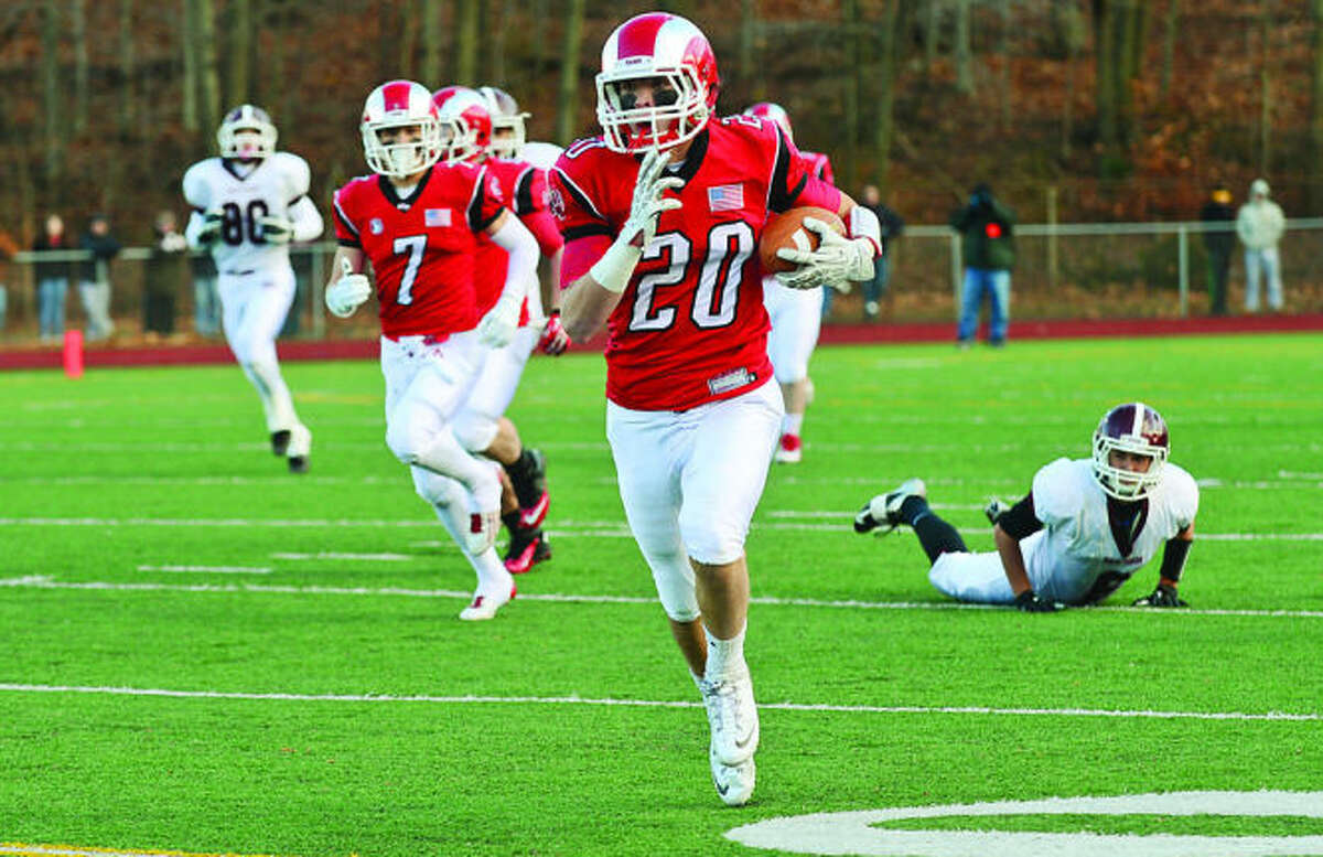 Hour photo / Erik Trautmann Kyle Smith of New Canaan runs to set up a field goal in their game against North Haven Saturday during the semi final championships in Milford.