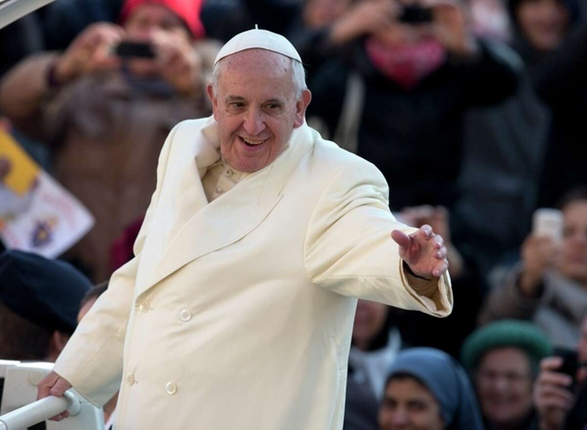 Pope Francis waves as he arrives for his weekly general audience in St. Peter's Square at the Vatican, Wednesday, Dec. 11, 2013. Pope Francis has been selected by Time magazine as the Person of the Year. In only his first year, the Pope was selected by the magazine's editors as the person who had the greatest impact on the world, for good or bad, during 2013. (AP Photo/Alessandra Tarantino)