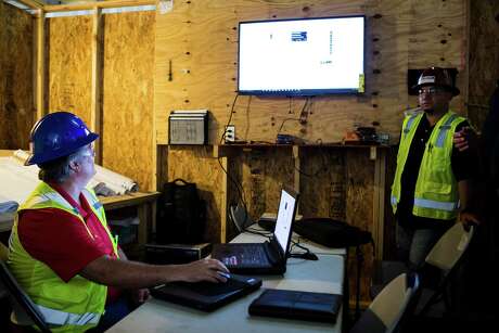 Brian Baker calls up a set of blueprints at a Comfort Systems USA, Inc., job site on Friday, May 13, 2016, in Houston.