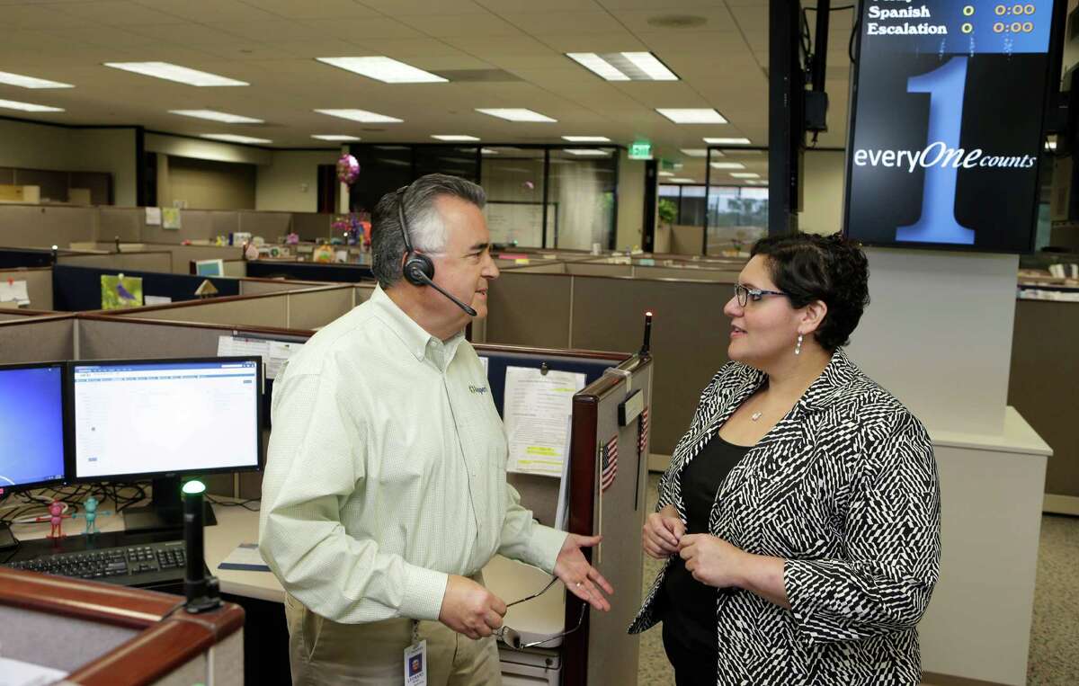 Leonard Perez, left, a senior contact center specialist, and Adelee Mirelez, right, the contact center director, talk at Insperity, 19001 Crescent Springs Dr., Wednesday, May 11, 2016, in Kingwood.