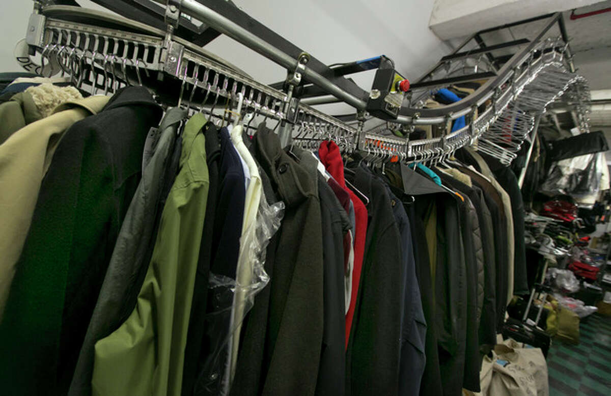 In this Tuesday, Dec. 17, 2013 photo, lost or forgotten coats hang on a motorized conveyor rack in the MTA Metro-North Lost and Found department, at New York's Grand Central Terminal. The handful of New York transit officials who run the lost-and-found units for the Metro-North Railroad and New York City Transit say they?’re not surprised by anything that comes through the door. (AP Photo/Richard Drew)