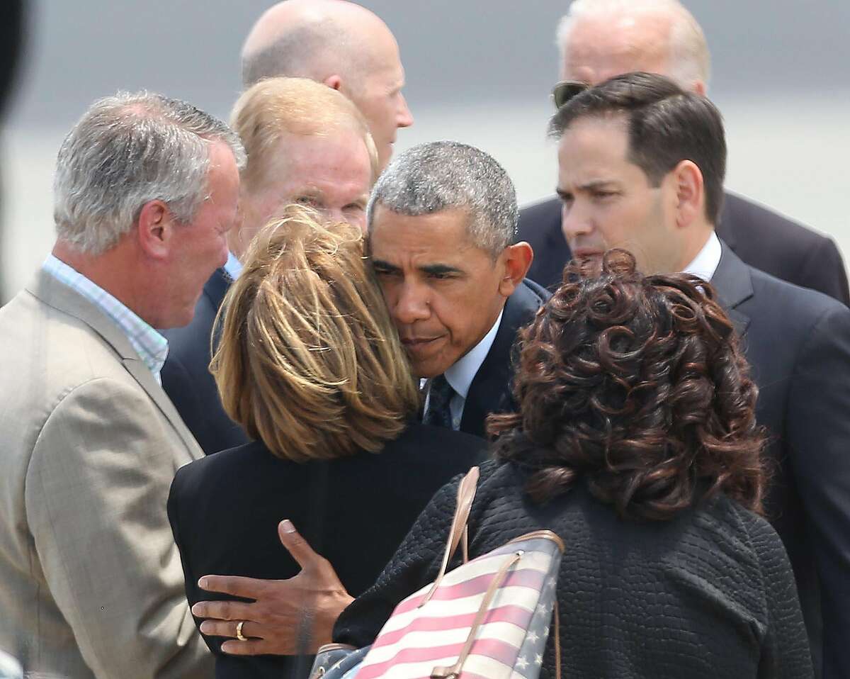 President Barack Obama hugs Orange County Mayor Teresa Jacobs upon the president's arrival at Orlando International Airport, Thursday, June 16, 2016, in Orlando, Fla. Obama is in Orlando today to pay respects to the victims of the Pulse nightclub shooting and meet with families of victims of the attack. (Stephen M. Dowell/Orlando Sentinel via AP) MAGS OUT; NO SALES; MANDATORY CREDIT