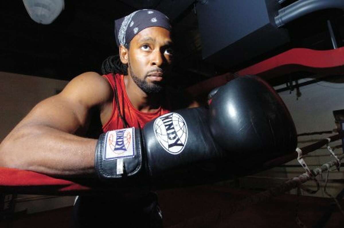 Photo/Alex von Kleydorff. Boxer Ahmad Mickens in the ring at his Revolution Fitness gym.