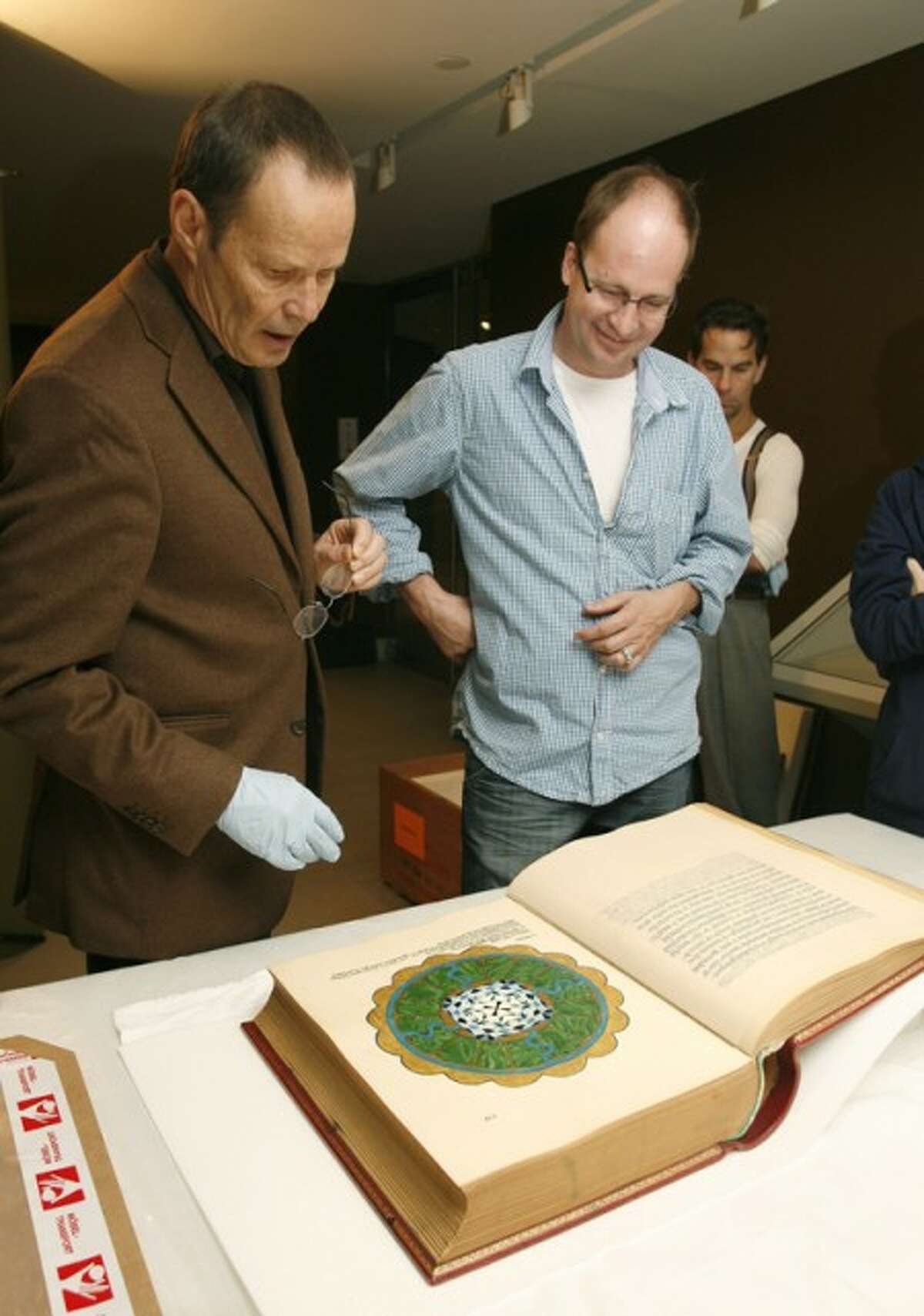 In this photo provided by the Rubin Museum of Art, the museum''s chief curator, Martin Brauen, left, and Felix Walder, great-grandson to Carl Jung, inspect Carl Jung''s "The Red Book" after it''s arrival at the Rubin Museum of Art in New York Tuesday, Sept. 29, 2009. "The Red Book," considered one of the most important unpublished works in the field of psychology, will be displayed to the public for the first time on October 7, coinciding with the first-ever publication of the book by W.W. Norton & Company. (AP Photo/Rubin Museum of Art, Stuart Ramson)