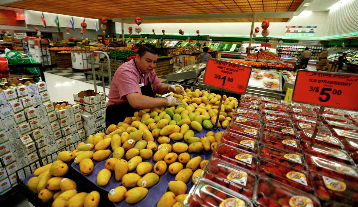 Roger Robles works on the mangos in the produce section at Fiesta Mart at 8130 Kirby Drive, Monday, May 23, 2016. Fiesta Mart is one of the top 10 private companies in the Chronicle 100 special section.