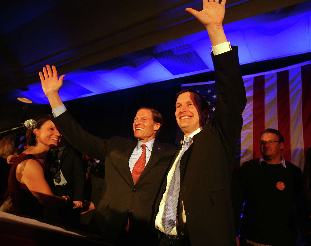 Chris Murphy, right, and Senator Richard Blumenthal wave to the crowd following Murphy's victory speech at the Hilton Hotel in Hartford on Tuesday, November 6, 2012.