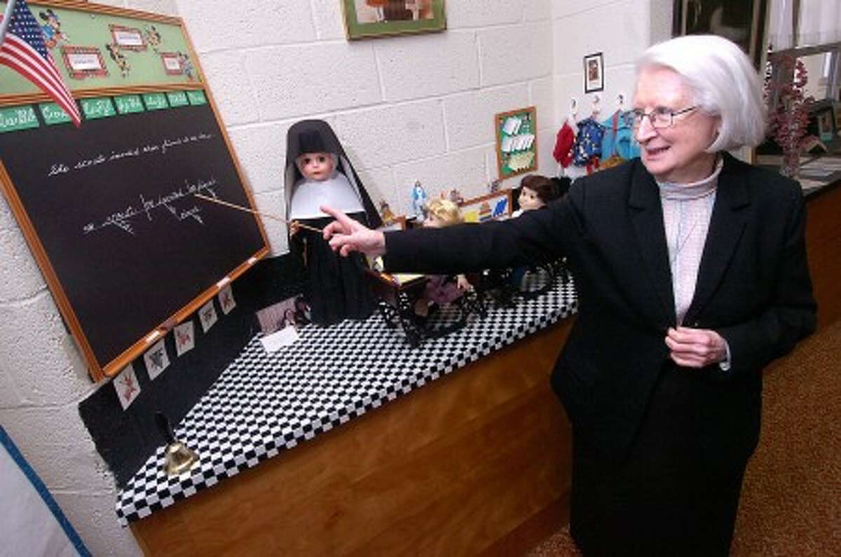 Photo/Alex von Kleydorff. School Sister Kay O''Connell shows a replica of a typical 60''s era classroom made by Sister M. Adele Shea, on display in the Heritage Room at School Sisters of Notre Dame, Wilton