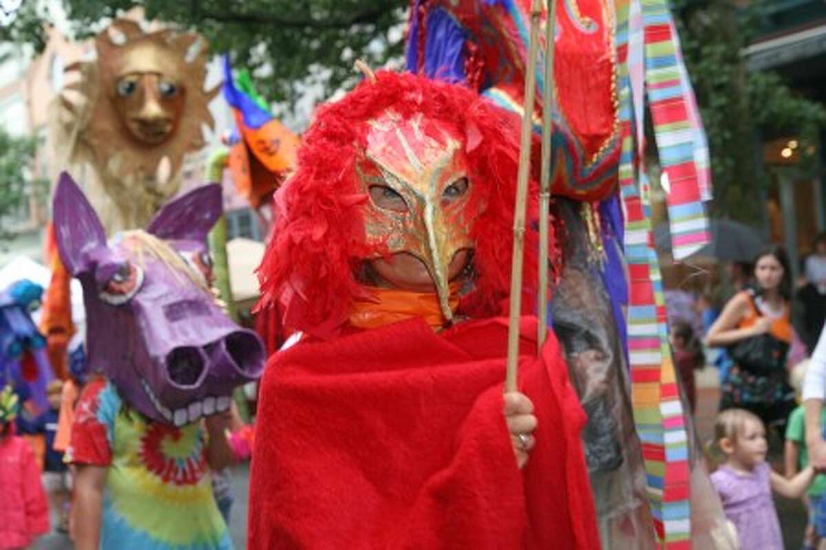 A person in costume walks down Washington Sreet in Norwalk Sunday afternoon during the SoNo Arts Festival''s annual Puppet Parade. Hour Photo / Danielle Robinson
