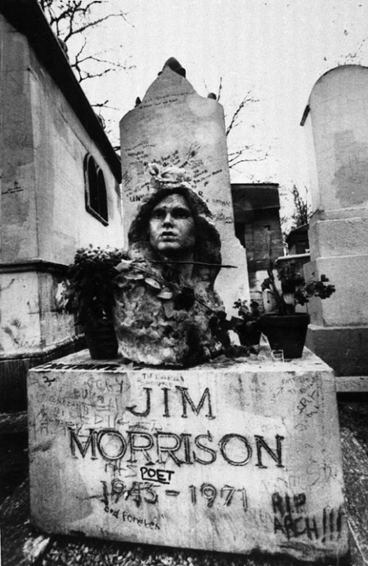 FILE- This Sept. 7, 1971 file photo shows the grave of Jim Morrison, lead singer of the rock group "The Doors," at the Pere Lachaise cemetery in Paris, France. (AP Photo/Joe Marquette,File)
