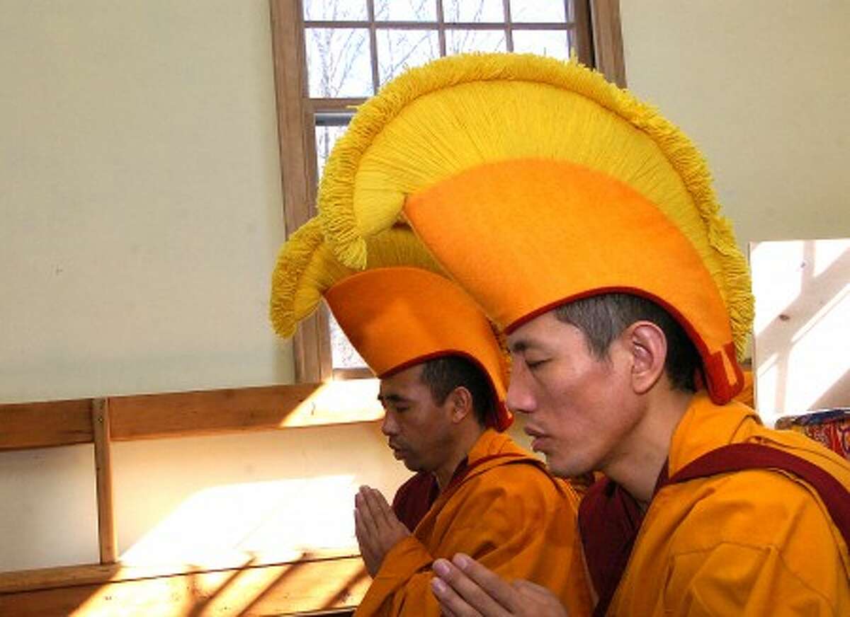 Photo/Alex von Kleydorff. Tibetan Monks chant during a ceremony as they prepare to create a Sand Mandela at Wiltons Friends Metting House on Sunday.