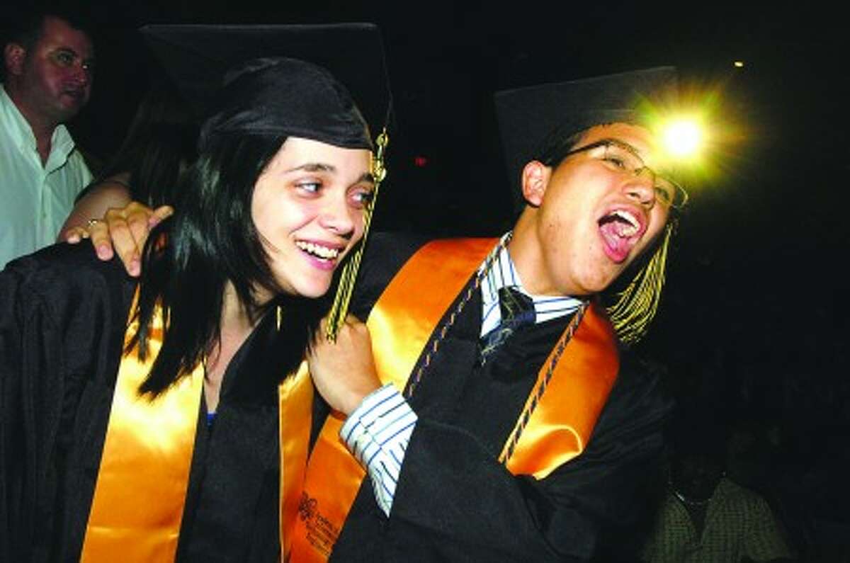 Photo/Alex von kleydorff. l-r Kelly Lafortune and John Leon about to get their diplomas cheer on a classmate at AITE graduation