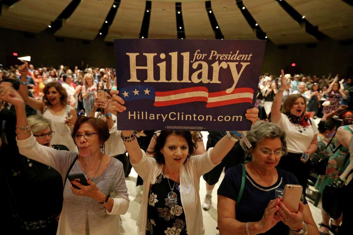 Hillary Clinton delegate Angela Collins, of El Paso, (center) holds a "Hillary for President" sign during the kickoff reception for the 2016 Texas Democratic Convention held Thursday June 16, 2016 at La Villita Assembly Hall.
