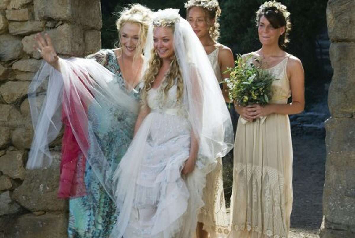 Donna Sheridan (Meryl Streep, from left) celebrates her daughter Sophie''s (Amanda Seyfried) wedding with Sophie''s friends Lisa (Rachel McDowall) and Ali (Ashley Lilley) in the musical romantic comedy "Mamma Mia!" (Courtesy Peter Mountain/Universal Studios/MCT)