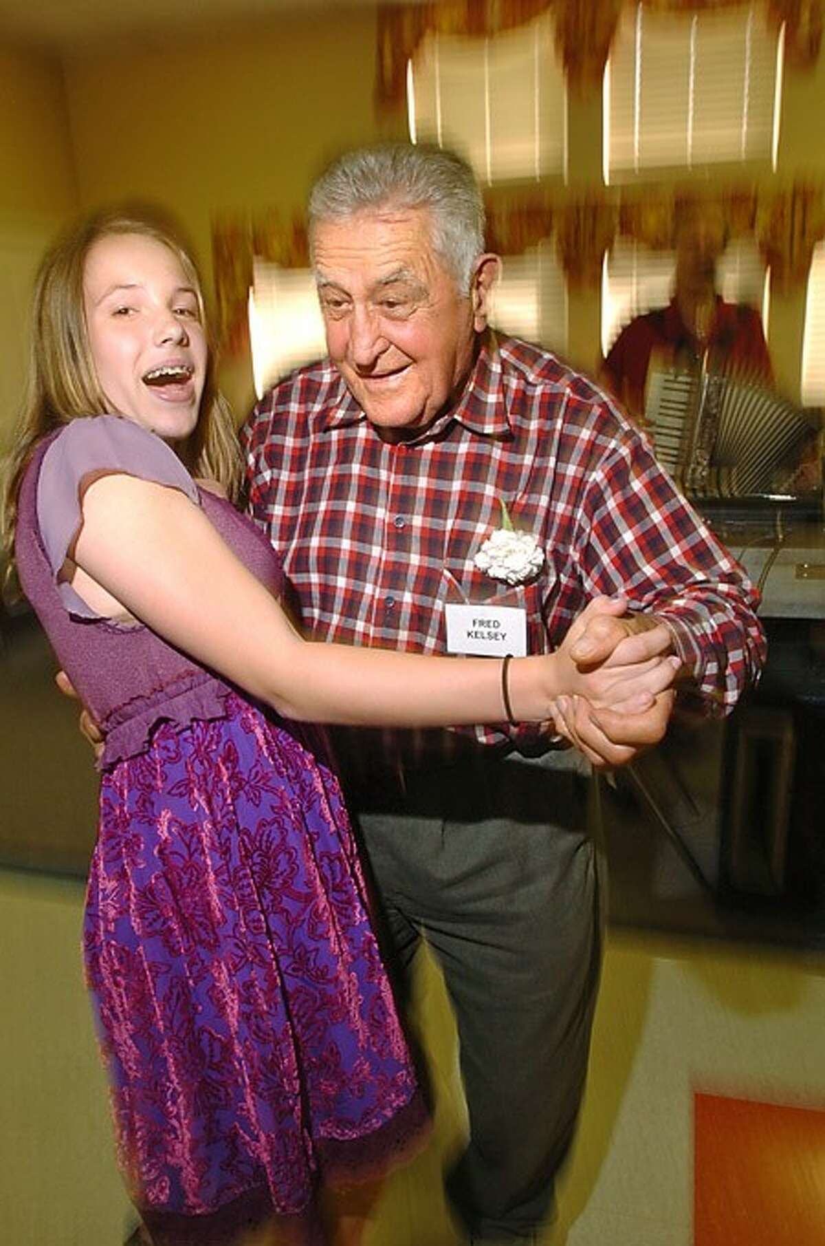 Fred Kelsey dances with Greens Farms Academy 7th grader during the school''s community service progam culmination Wednesday at Elderhouse. Hour photo / Erik Trautmann