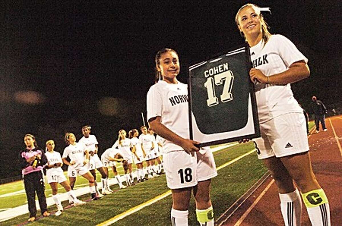 Norwalk girls soccer players, Anamilena Moreno and Sara Costa hold up the retired jersey of the late Chelsea Cohen who was a Norwalk high school student and played for the school''s soccer team/hour photo matthew vinci