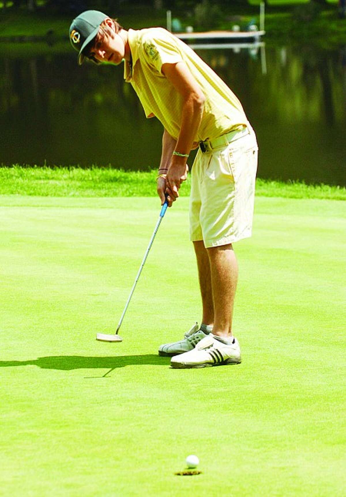 Trinity Catholic golfer Steven Custardo putts on the first hole during the Fitzpatrick City Golf Championship at Woodway in Darien. Times photo/Erik Trautmann