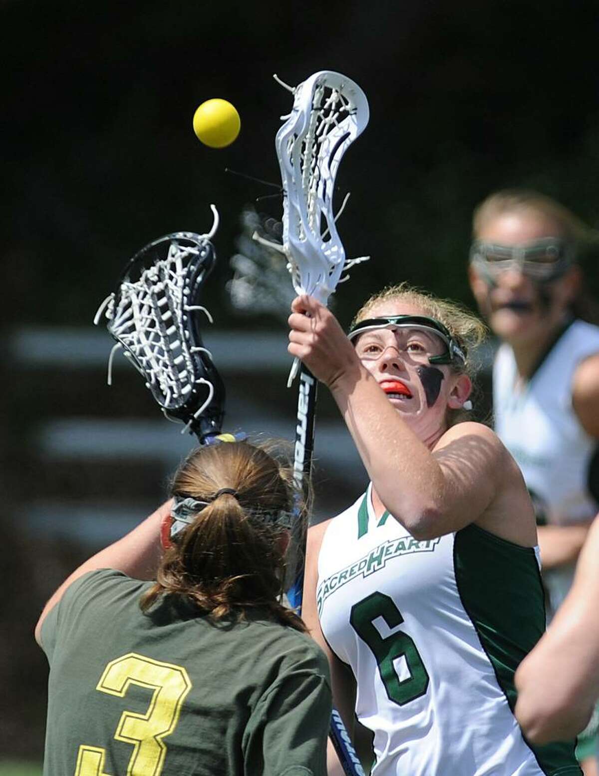 Tory Bensen, # 6 of Convent of the Sacred Heart, right faces-off against Alexa Pujol, # 3, of Greenwich Academy, during lst half action at GA, Saturday. GA defeated CSH, 19-15.