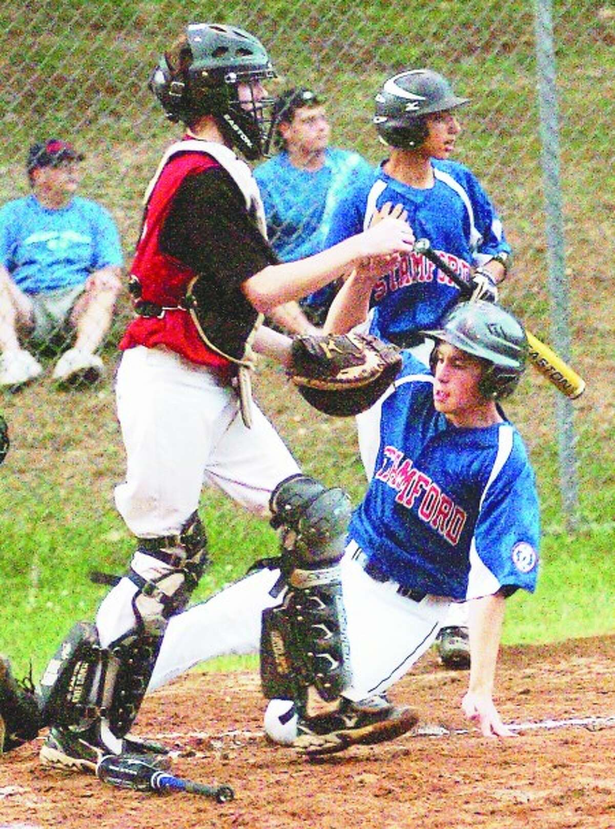 Stamford 13-year-old All-Star Conner Amann slides into home safely against Fairfield during a Babe Ruth State Tournament losers bracket game on Tuesday at Unity Park in Trumbull. Photo/Matthew Vinci