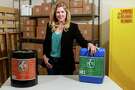 Lauren Thompson Miller, CEO and co-founder of A-76 Technologies, in the company's warehouse with 5-gallon cans of A-76 Super, on the left, and A-76 Green. The products also come in 55-gallon drums, and in aerosol or twist top bottles for household use. (For the Chronicle/Gary Fountain, May 20, 2016)