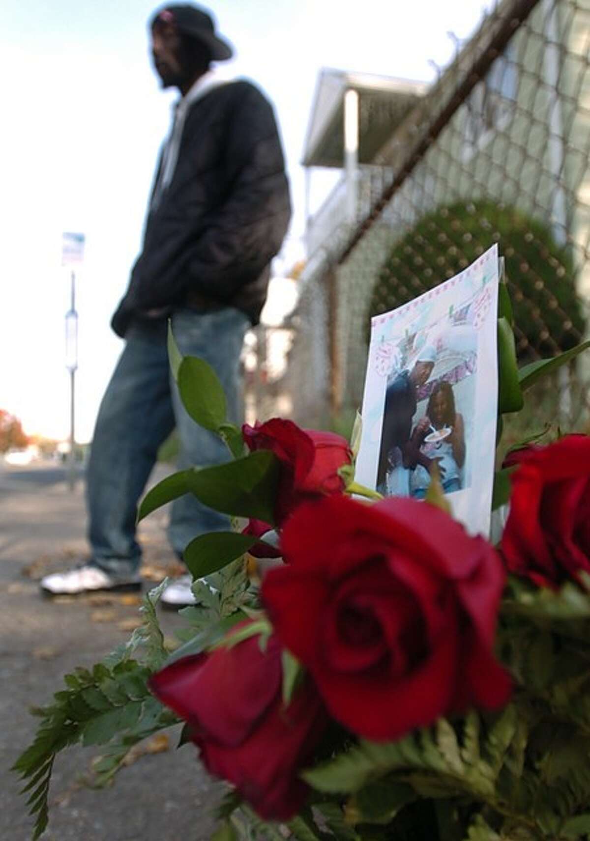 Friends Michael "Mizzy" Robinson, gather at a memorial to him the morning after he was gunned down at South Main and Grove streets in South Norwalk. Hour photo / Erik Trautmann